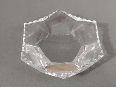 a clear glass bowl on a table with a white background