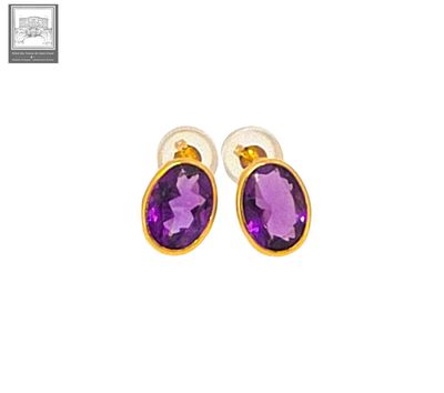 an image of a pair of earrings with a purple stone