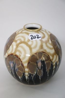 a vase with a design on it sitting on a table