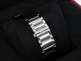 a close up of a watch in a case on a white surface