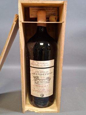 une bouteille de vin dans un coffret en bois sur une table