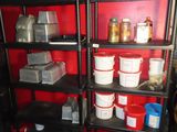 many buckets and pans on a shelf in a room