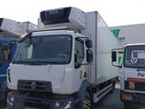 three trucks that are parked in a parking lot