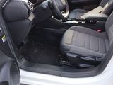 the interior of a car with the door open and the passenger seat down