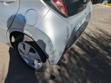 a silver car that is parked on the side of the road