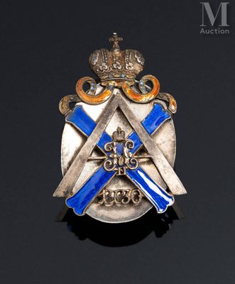 a close up of a silver and blue badge on a black surface