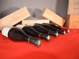 several bottles of wine are lined up in a row on a table