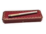 an image of a pen sitting on top of a red box