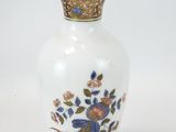 a white vase with blue and pink flowers on it