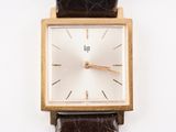 an image of a close up of a wrist watch on a white surface