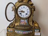 a clock that is sitting on top of a glass shelf