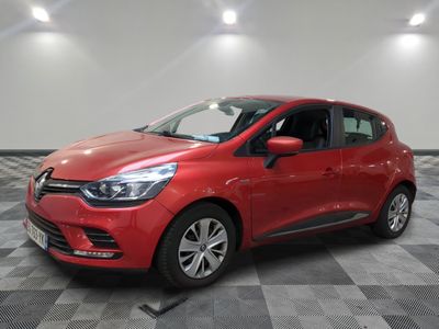 a red car is parked on a checkered tile floor