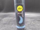 an image of a bottle of aqua water sitting on a counter