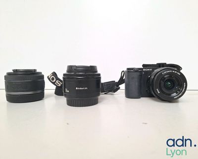 two cameras sitting next to each other on a table