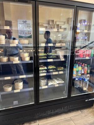 a glass case with food inside of it in a store