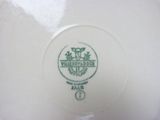 a white plate with a green logo on it