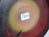 a red and yellow bowl with a sticker on it