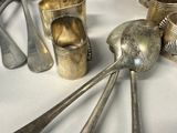 a lot of spoons and utensils on the table