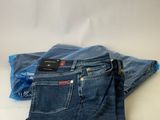 a pair of jeans sitting on top of each other on a table