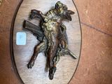 a bronze statue of a man on a horse on a table