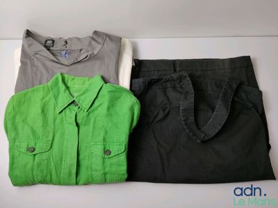 two shirts and a tote bag are sitting on a table