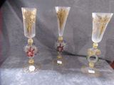 three glass vases sitting on a table next to each other