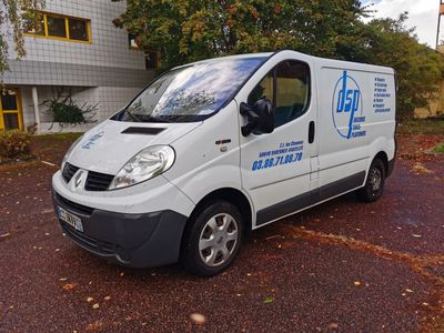 a white van parked in front of a building
