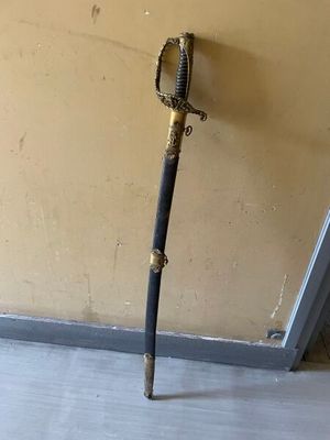 a sword that is standing up against a wall