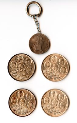 four british coins are arranged in a row on a white surface