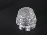 an image of a clear glass candle holder on a black background