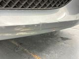 a close up of a car ' s bumper with rust on it