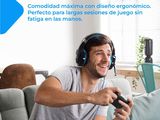 a man sitting on a couch with headphones on playing a video game