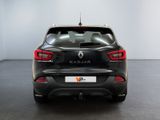 the rear end of a black car in a white room