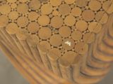 a close up view of a wooden chair with circles on it