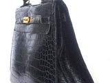 black alligator skin handbag with gold hardware and handle