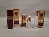 three bottles of perfume sitting next to each other on a white surface