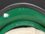 a close up of a green and white bowl with a white cloth