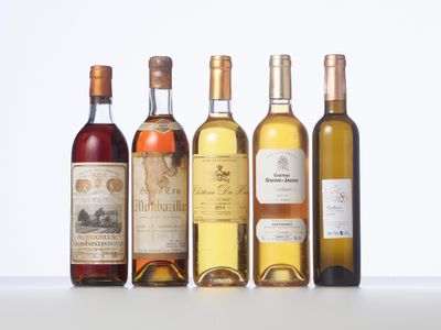 several bottles of wine are lined up on a table