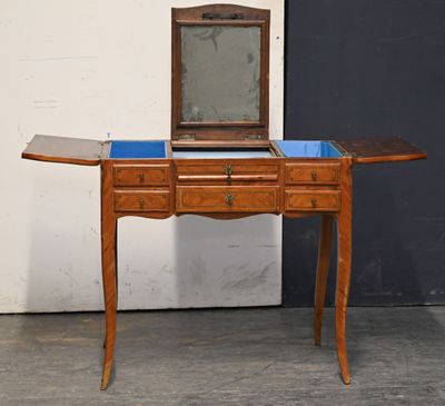 a small wooden table with a mirror on top of it