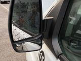 a side view mirror of a car on the side of the road