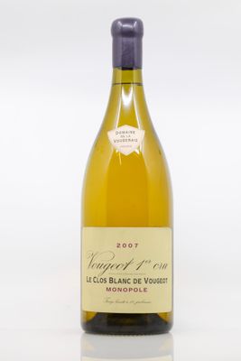 the bottle of white wine is sitting on a white surface