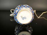 a close up of a blue and white cup on a table