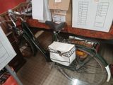 a bike that is parked in a room with a lot of boxes on the wall