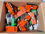 a cardboard box filled with assorted bottles and batteries