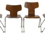 three wooden chairs sitting next to each other on a white surface