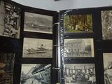a person holding a book with pictures of ships on it