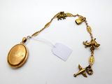 an image of a gold necklace with a coin and a bird charm