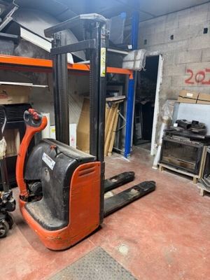 a forklift in a garage with a lot of tools