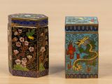 pair of chinese cloissant boxes with dragon and flowers on them