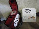 a red case with a clock on it next to a box